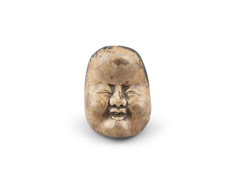 A WOOD NETSUKE OF OKAMEJapan, 19th centuryShaped as a face of Okame, the back inscribed with a signature reading Deme Uman. O