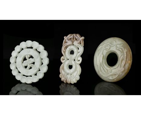 A GROUP OF THREE (3) JADE CARVINGSChinaThe first one is an open-worked 'ruyi' plaque. The second one is carved with two confr