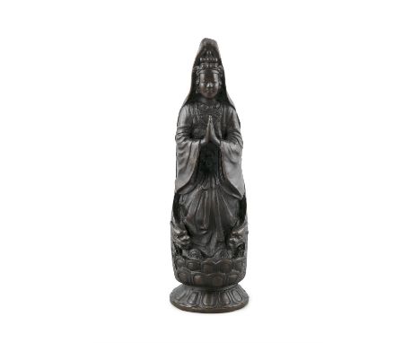 A HEAVY CASTED DARK PATINE BRONZE MODEL KANNONJapan, Circa 1900The goddess of mercy is depicted standing on a lotus base, her