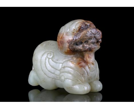 A CELADON AND RUSSETS MYTHICAL WINGED BEASTChina, Modern, After a Han Dynasty modelCarved out of a celadon and russets stone,