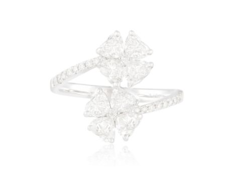 A DIAMOND FLOWER RINGComposed of two flowerheads set with heart-shaped diamond petals centring a brilliant-cut diamond, betwe