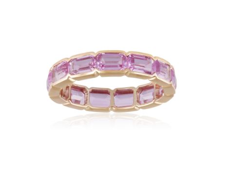 A COLOURED SAPPHIRE ETERNITY RINGComposed of a continuous line of rectangular-cut pink sapphires within collet-setting, mount