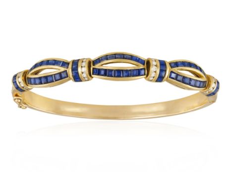 A SAPPHIRE AND DIAMOND BRACELETThe hinged bangle with openwork bombé design, set with calibré-cut sapphires with brilliant-cu