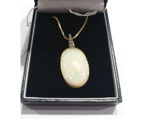 A 14ct Opal and Diamond Pendant on a Chain.