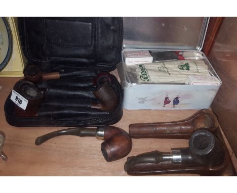 Two Peterson's of Dublin Pipes, one with Irish hallmarked silver band (on a stand), together with four Carey Magic Inch pipes