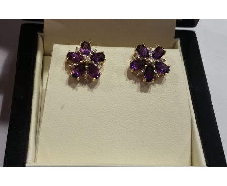 A Pair of Gold Diamond and Amethyst Cluster Earrings.