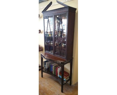 An Edwardian Chippendale Revival Bookcase with Blind Fret Work and Pierced Detail, having a pair of astragal glazed doors to 