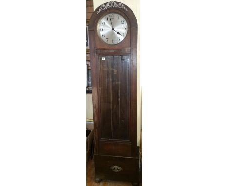 An Oak Longcase Clock, having an arched top enclosing a silvered dial with Arabic numerals and with a striking and chiming mo