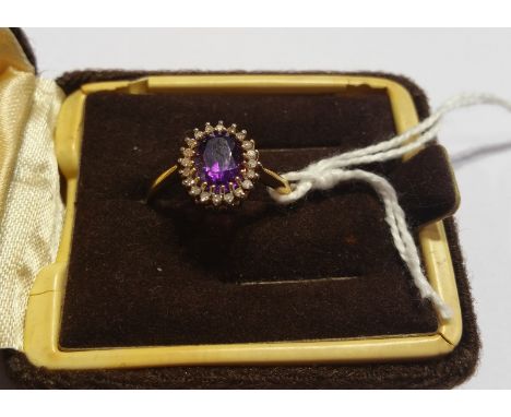 A 9ct Diamond and Amethyst Cluster Ring.
