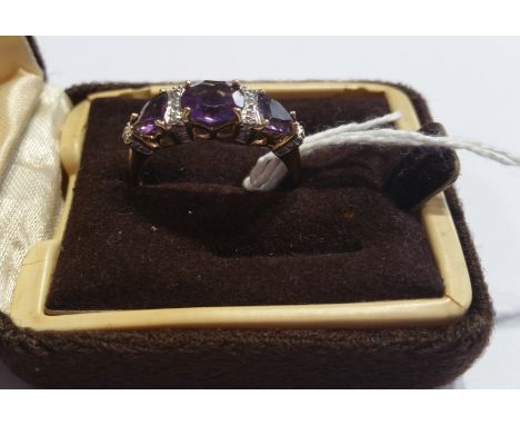 A 9ct Diamond and Amethyst Cluster Ring.