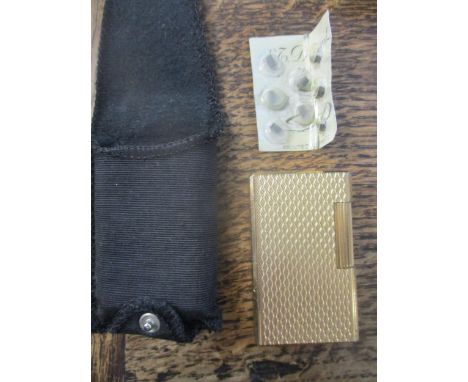 An S T Dupont gold plated lighter in slip case with spare flints Location: Cab 