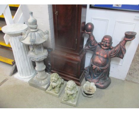 A selection of garden ornaments to include a Buddha statue, Chinese pagoda, marble effect stand, lions and hand ornaments 