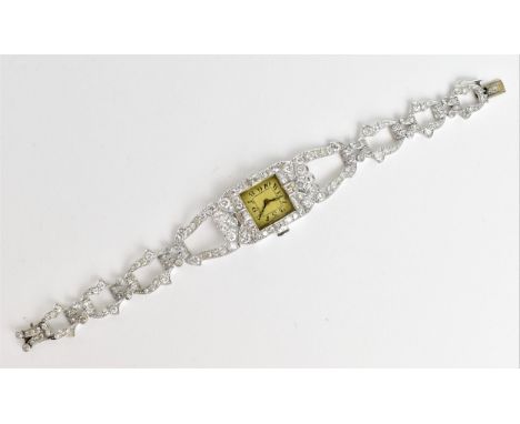 A vintage ladies, testing as Platinum, diamond set manual wind cocktail watch, having a rectangular dial with Arabic numerals