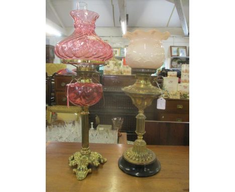 A Duplex brass oil lamp, converted to electricity, with cascade swag decorated cranberry reservoir, and quilted cranberry gla