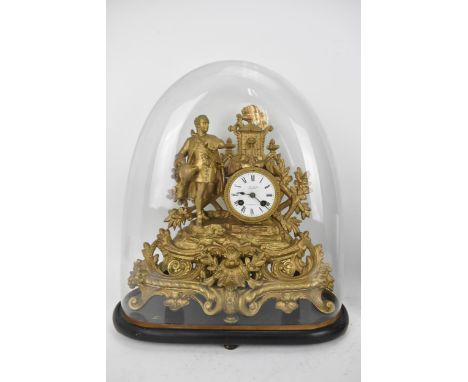 A late 19th century French gilt metal mantle clock, the case decorated with a figure, pierced floral scroll base and urn shap