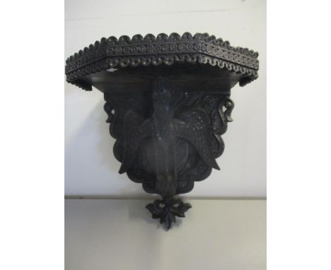 A Black Forest style wooden wall bracket, the support below in the form of a carved mystical bird Location: 2.4 