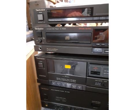 A Technics stereo with a record player ad a pair of Pioneer speakers in a teak cabinetLocation:RAF 