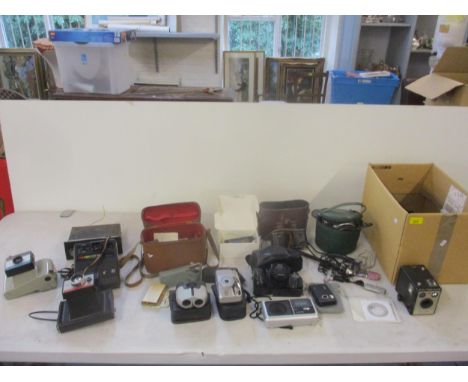 A mixed lot of Polaroid instant cameras, digital cameras, film cameras to include a Kodak Brownie model 1, binoculars, light 