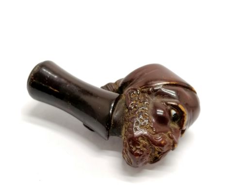 Antique carved pipe bowl in the form of an Eastern gentleman wearing a hat with tassel and has beaded eyes - 6.5cm long
