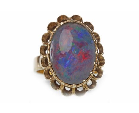 OPAL TRIPLET DRESS RINGset with a large oval opal triplet 17.5mm long within a pierced scalloped border, marked 9CT, size R, 