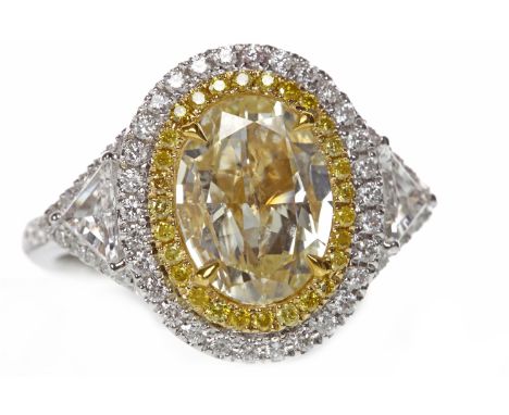 IMPRESSIVE YELLOW DIAMOND RINGset with an oval diamond of 1.99 carats, surrounded by a halo of round yellow diamonds with a f