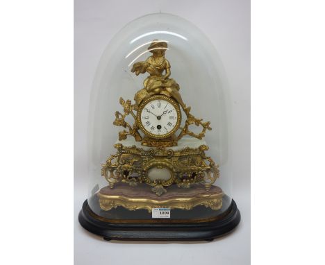 Late 19th century gilt metal mantle clock, white enamel dial surmounted by figure of a lady, single train movement on plinth 