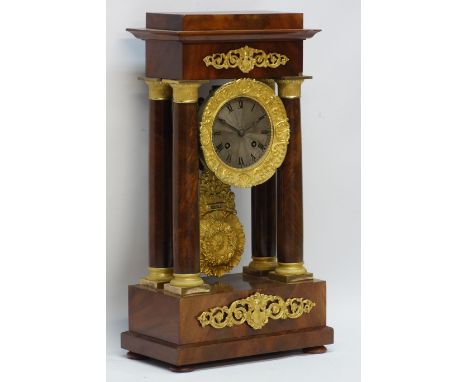 Victorian gilt metal mounted mahogany portico clock, the stepped top on Doric columns, silvered dial and shell pendulum on bu