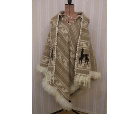 An Alpaca woollen poncho&nbsp;with tie front, matching scarf, fur trim and an appliqued alpaca onto the scarf, a blue Alessio