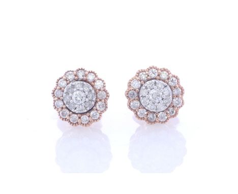 Nine round brilliant cut diamonds create a round cluster and are surrounded by a halo of thirteen diamonds in each of these 9