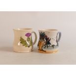 Two Moorcroft mugs to include Thistle (crazing and staining inside) and Palm Tree (2)