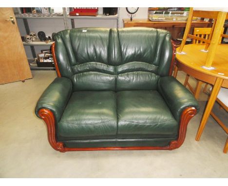 A two seater green leather sofa