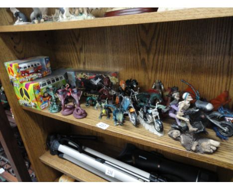 A shelf of fantasy figures including riding motor bikes 2 boxed Maisto VW campervans