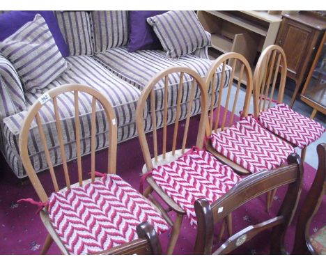A set of 4 light oak ERCOL hoopback chairs