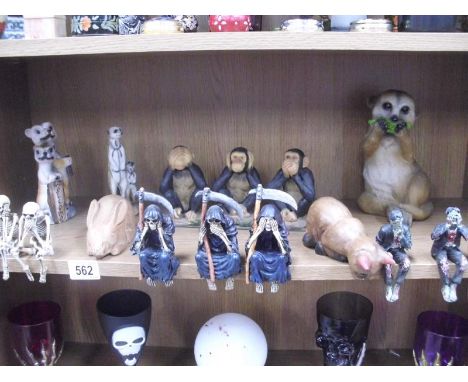 A shelf of animal figures and various See No / Hear No / Speak No Evil Halloween related figures etc