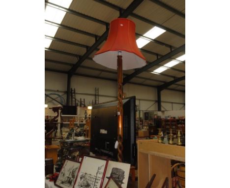 A barley twist standard lamp with centrepiece and shade