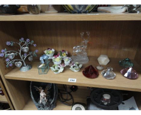 A shelf of posies ornaments, other ornaments and crystals etc