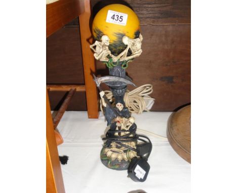 A skeleton figural lamp