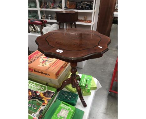 A pie-crust top tripod table