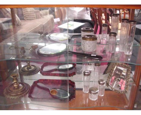 A collection of dressing table items including mirror, glass bottles, candlestick etc