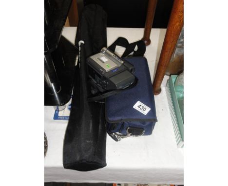 A Panasonic NV-DS65 camcorder with tripod