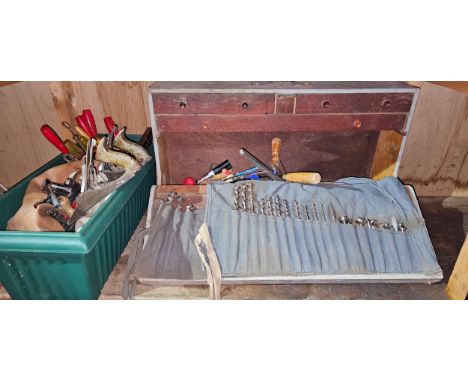 A woodeworkers tool box with various workworking tools and drills 