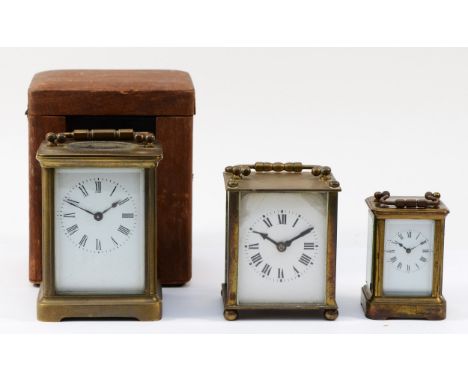 A 20th century English brass carriage clock, having 8 day movement, with travel case, 11cm tall, together with two smaller Fr