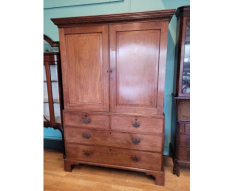 A late 19th century converted mahogany linen-press the upper part lacking shelves, fitted with clothes rail, enclosed by a pa