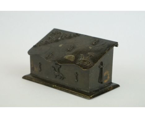 19th century Metal Matchbox / Snuff Box in the form of a Casket with sloping lid and embossed decoration including a Hound wi