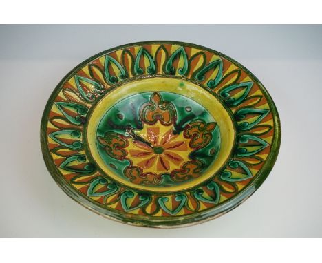 Della Robbia Pottery (Birkenhead 1894-1906) Dish with incised decoration in shades of green, brown and yellow, incised marks 