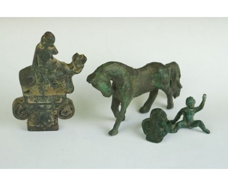 A collection of four metal artifacts to include a ring and a horse. 