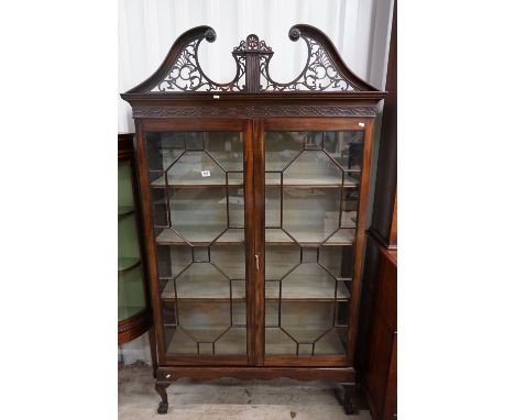 Early 20th century Mahogany Glazed Display Cabinet in the Chippendale manner, with pierced carved broken swan neck pediment, 