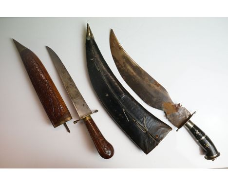 Two asian knives / daggers to include a wood and brass mounted example with carved scabbard.