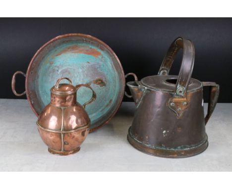 A small collection of copper ware to include a preserve pan, a large jug and a tea caddy. 