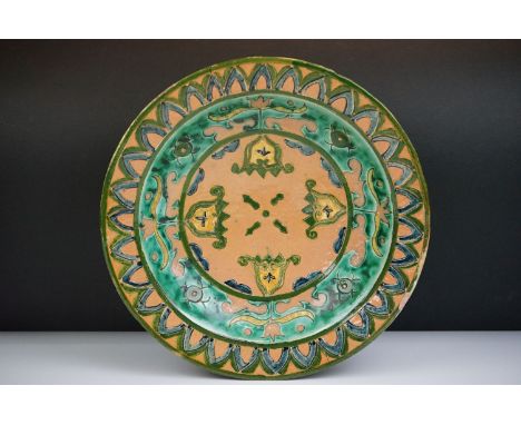 Della Robbia Pottery (Birkenhead 1894-1906) Shallow Dish with incised decoration in shades of green, ochre blue and yellow, i